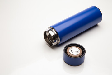 Aluminum blue bottle water placed on a wooden table in a restaurant or shop, Concept: Reduce plastic waste to recycle reusable and ecology nature, stainless glossy metal-containing liquid for sport