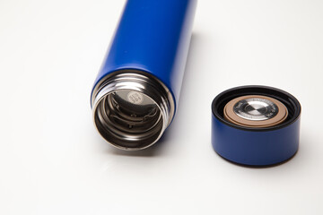 Aluminum blue bottle water placed on a wooden table in a restaurant or shop, Concept: Reduce plastic waste to recycle reusable and ecology nature, stainless glossy metal-containing liquid for sport