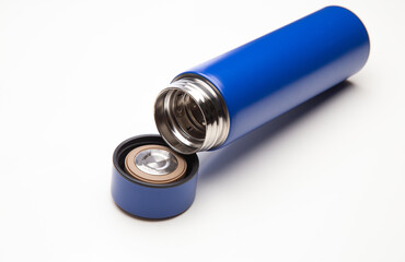 Aluminum blue bottle water placed on a wooden table in a restaurant or shop, Concept: Reduce plastic waste to recycle reusable and ecology nature, stainless glossy metal-containing liquid for sport