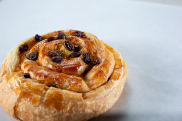 A closeup view of a raisin roll pastry.