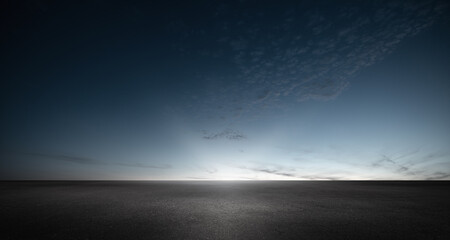 Black Asphalt Floor Background and Dark Blue Night Sky Sunset Horizon with Subtle Clouds