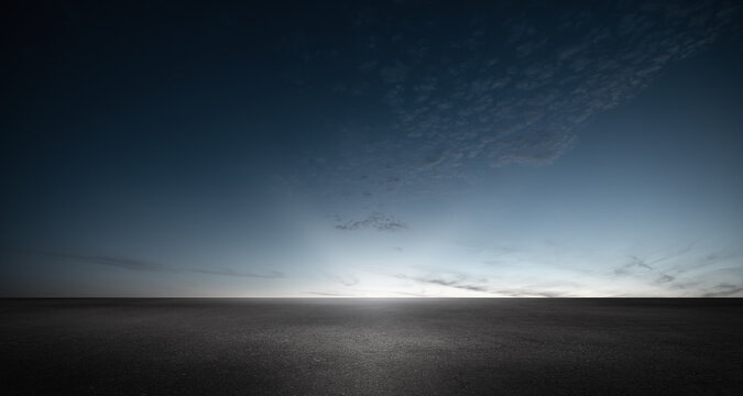 Black Asphalt Floor Background And Dark Blue Night Sky Sunset Horizon With Subtle Clouds