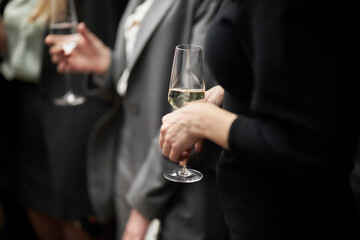 The girl holds a glass in her hand. Champagne. A party 