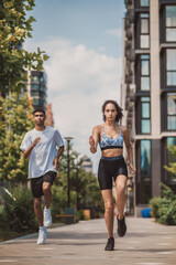 Two young African American joggers running ahead