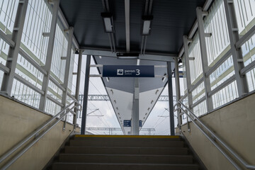 Entrance stairs to train station platforms from pedestrian underpass in Poland. Words in Polish language peron, tor and sektor means platform, track and sector. - obrazy, fototapety, plakaty