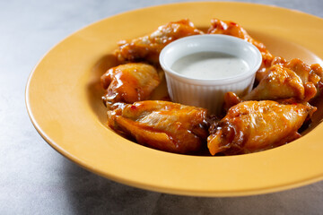 A view of a bowl of buffalo wings.