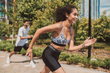 Smiling young sportswoman taking part in a sporting event
