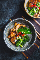 Ramen soup  with mushrooms, vegetables, glass noodles and  pork