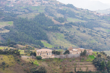 Fototapeta premium Scenic view of a village on the top of the mountain on a cloudy day.