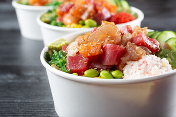 A closeup view of three poke bowls. © DAVID