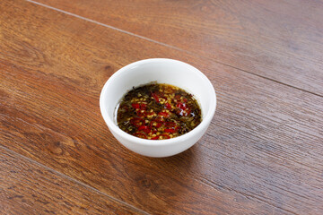 A view of a condiment cup of Asian chili sauce.