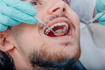 patient mouth with dentist tools