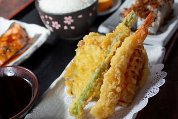 A closeup view of a bento box, featuring tempura vegetables.