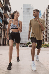 Obraz premium Joyous couple performing an aerobic exercise outdoors