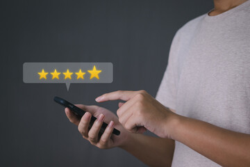 Hand of Businessman using smartphone with popup five star icon, Reviews and feedback for customer service Excellence Survey or satisfaction assessment, Highest customer service ratings