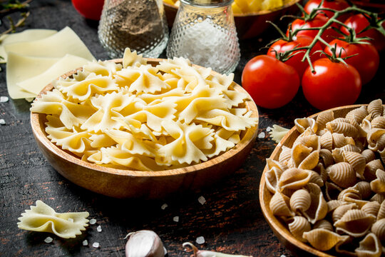 Different types of raw paste in bowls with garlic, tomatoes and spices.