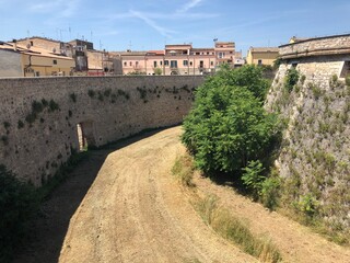 Fototapeta na wymiar Walls of the Aragonese Castle with moat of Venosa historic city