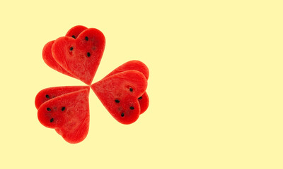 Red Watermelon Pulp Hearts in shape clover flower on yellow background. Design element. Watermelon pieces. Season sale fruits  and berries. Web banner. Positive Love emotions