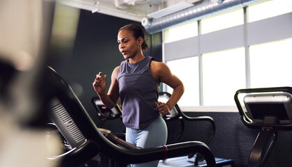 Woman running on a gym treadmill