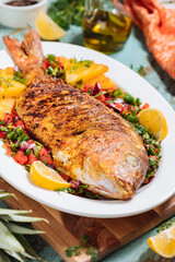 Red Snapper with ingredients. Prepared in tropical taste with Pico de Gallo and pineapple. Fresh and tasty fish and seafood. 