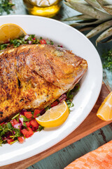Red Snapper with ingredients. Prepared in tropical taste with Pico de Gallo and pineapple. Fresh and tasty fish and seafood. 