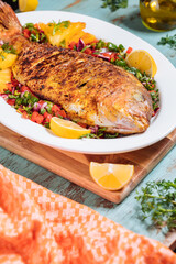 Red Snapper with ingredients. Prepared in tropical taste with Pico de Gallo and pineapple. Fresh and tasty fish and seafood. 