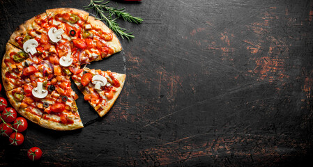 Pieces of delicious Mexican pizza with cherry and rosemary.