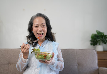 Beautiful senior woman eating healthy breakfast.