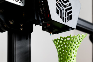 3d printer with a vase printed with pla filament