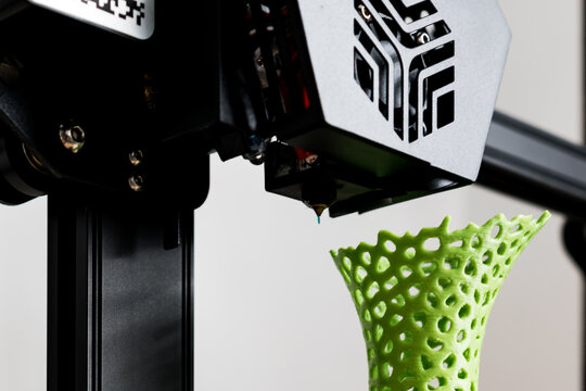3d printer with a vase printed with pla filament
