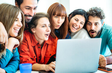 Happy genz employee friends having surprised fun together on laptop pc at startup studio - Millenial life style influencer concept with happy people on video chat conference call - Bright azure filter