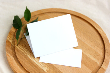 two blank cards on a round cutting board. natural background, mockup, scene creator.