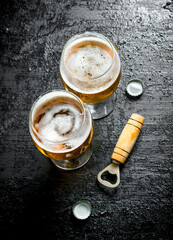 Glasses of beer and opener.