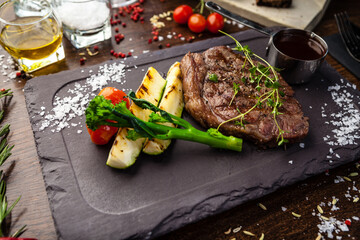 Black Angus New York steak. Marbled beef sirloin from Uruguay. Delicious healthy traditional food closeup served for lunch in modern gourmet cuisine restaurant