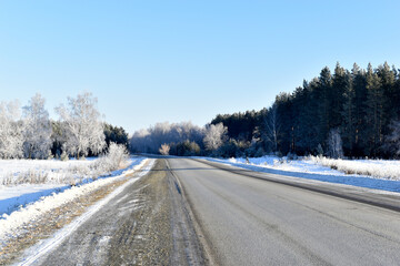 A high-speed road in a snow-covered field. Snowy road in winter.