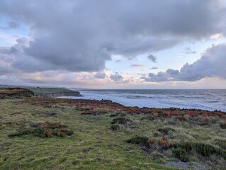 Half Moon Bay coastline, sunset over the sea, storm over the sea, clouds over the sea, California coast, pacific ocean coastline, breathtaking ocean view, west coast, view from the cliffs