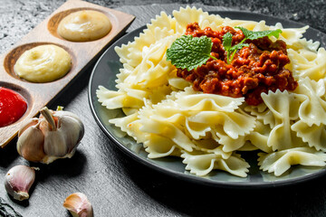 Farfalle pasta with garlic and Bolognese sauce.