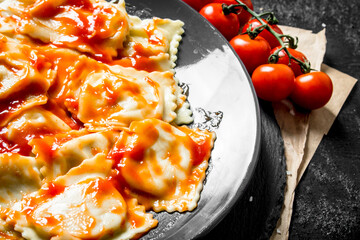 Ravioli with tomatoes and sauce.