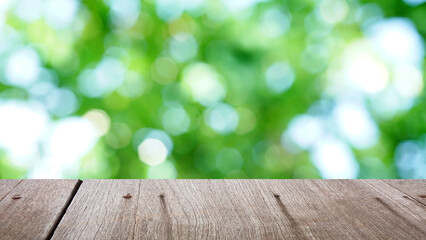 Green bokeh background with brown wood plate .