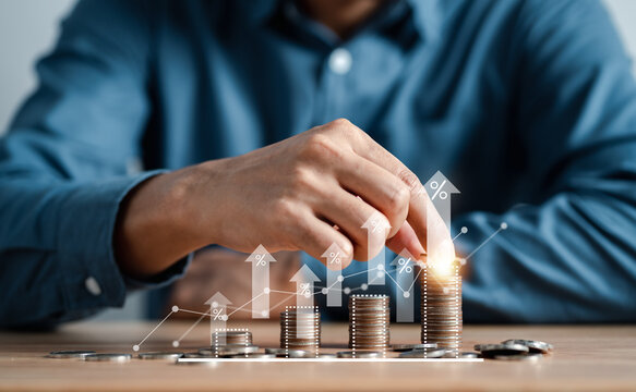 Businessman stacking money coins accounting for increase financial interest rate and business investment growth from dividend, Business Finance and Money, Save money for prepare in the future.