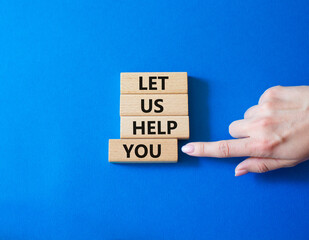 Let us help you symbol. Wooden blocks with words Let us help you. Businessman hand. Beautiful blue background. Business and Let us help you concept. Copy space.