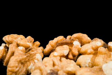 close up peeled walnut kernels isolated on black