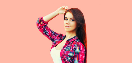Fototapeta premium Portrait of beautiful young brunette woman on pink background