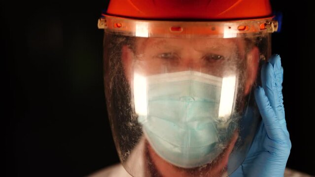 Australian person putting on safety equipment and a mask in a workplace in an industry 