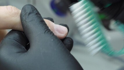 Electric nail file drill in action. Manicure