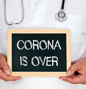 Corona is over, medical doctor with chalkboard, covid or covid-19 pandemia