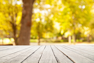 light wooden table on blurred nature bokeh background