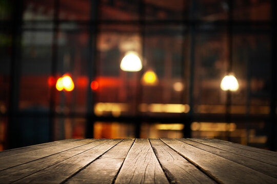 Empty workplace, table on the background of blurred cafe lights