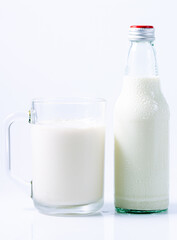 Milk bottle and glass of milk on white background,Glass and bottle with milk drink, isolated on white background