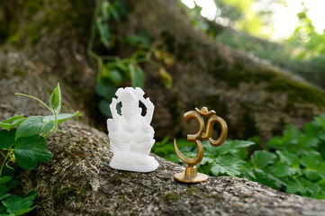 Figurine Trishakti Yantra and Ganesha for yoga and meditation on a natural background. OM-AUM.